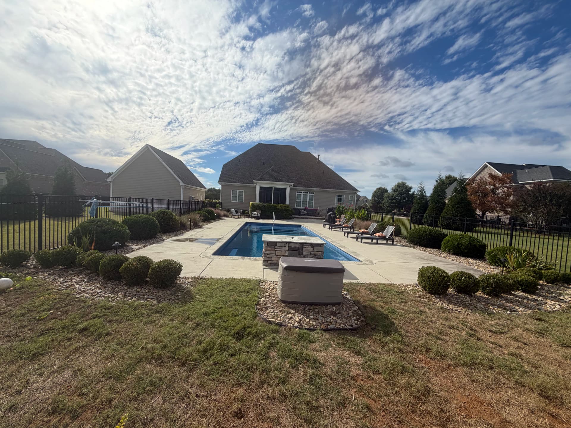Shrub Trimming and Planting Cleanup Around a Pool Backyard image